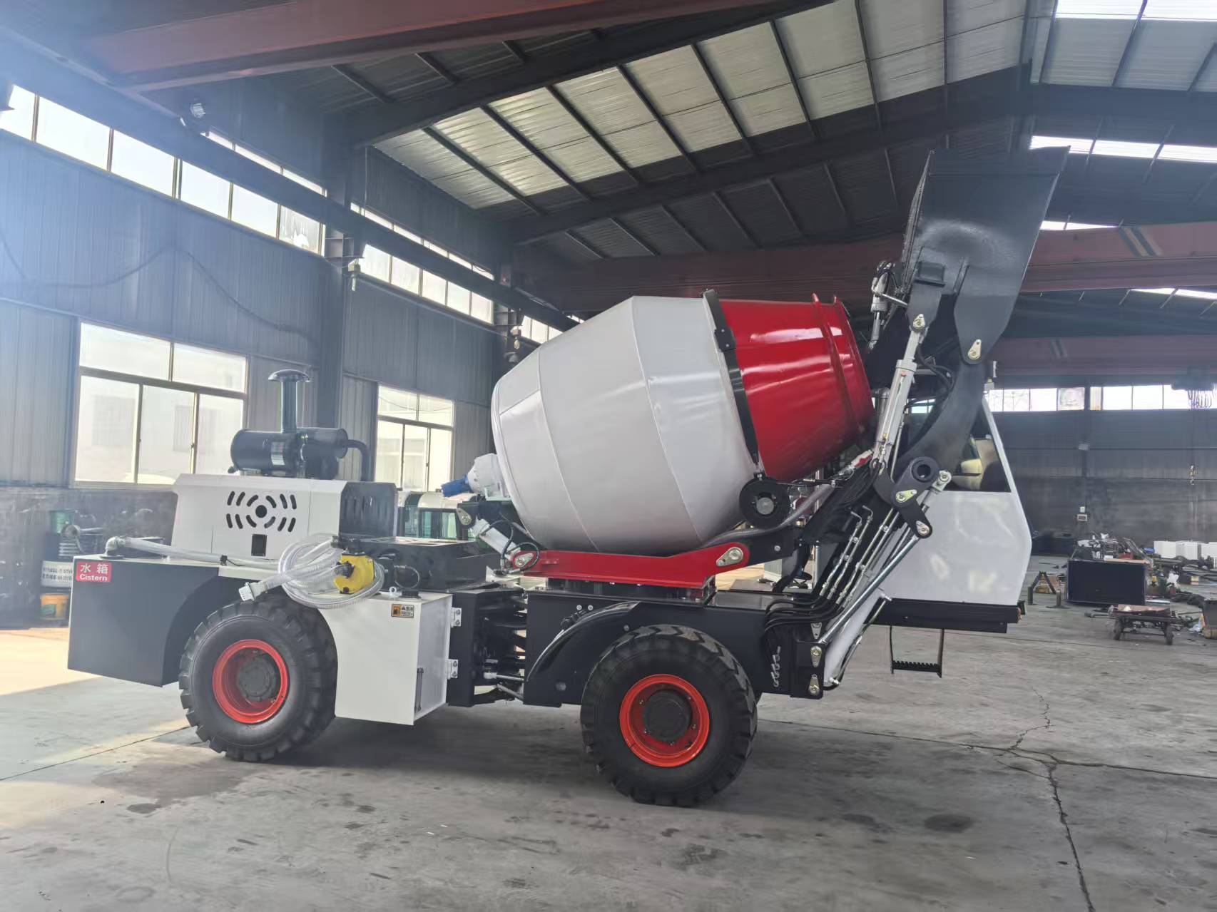 Self-loading concrete mixer with front loading bucket